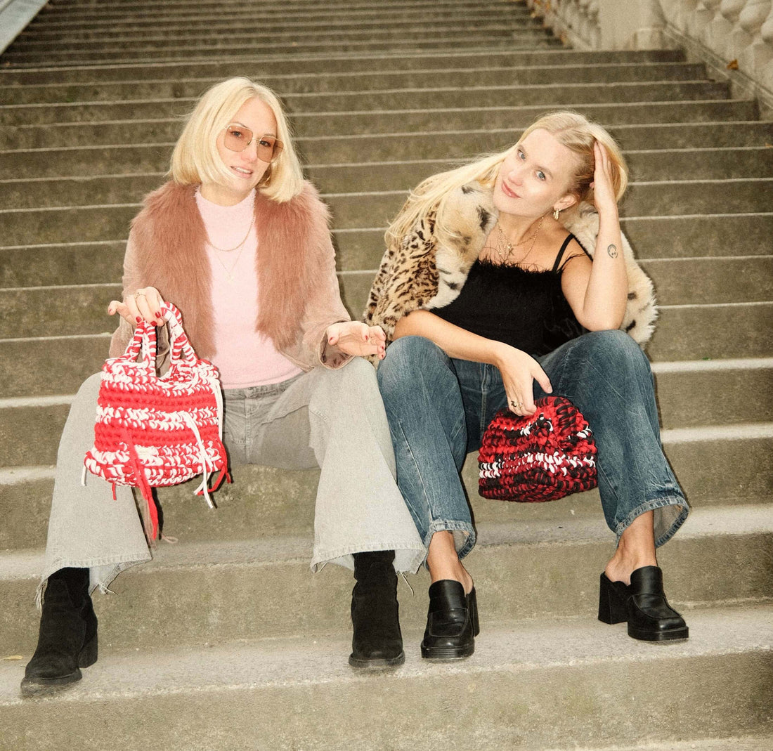 free crochet clutch pattern - models sitting on the stairs with bags