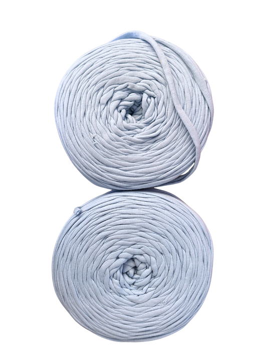 rolls of baby blue tshirt yarn on a white background from the top