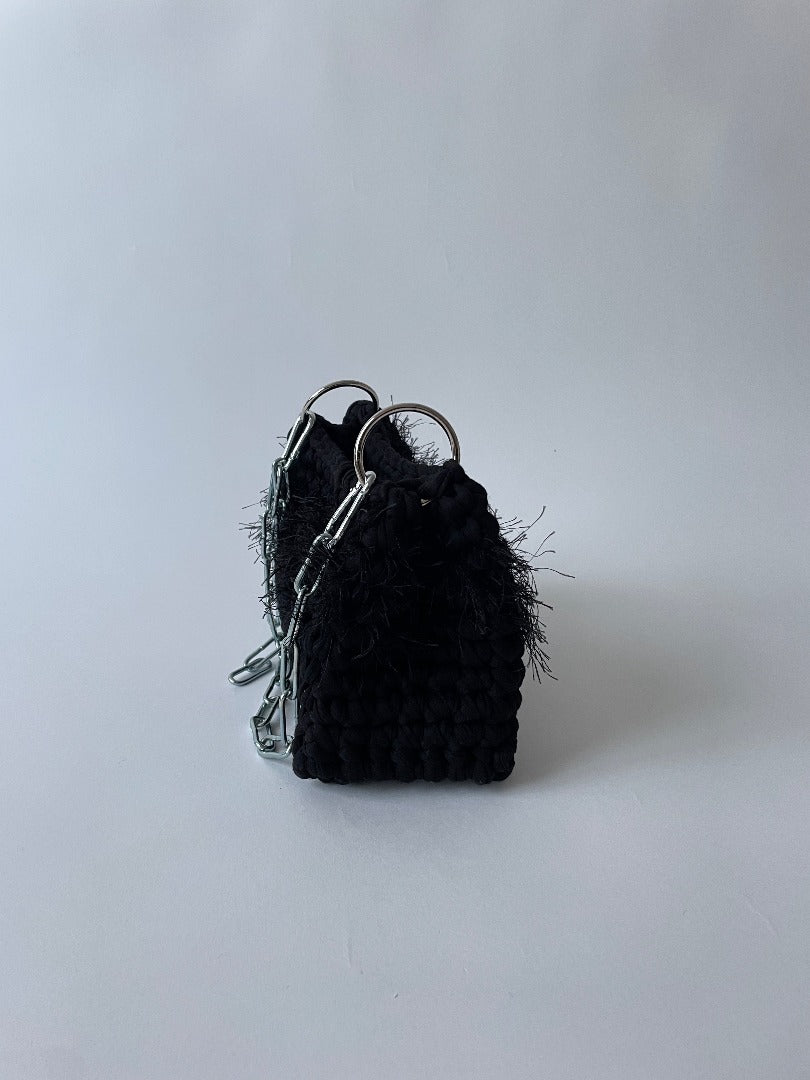 black fluffy crochet bag with a silver chain handle