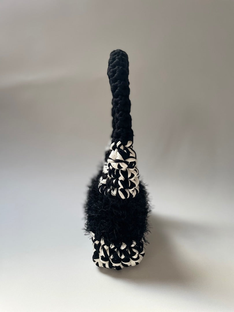 black and white crochet bag with fluffy black detailing