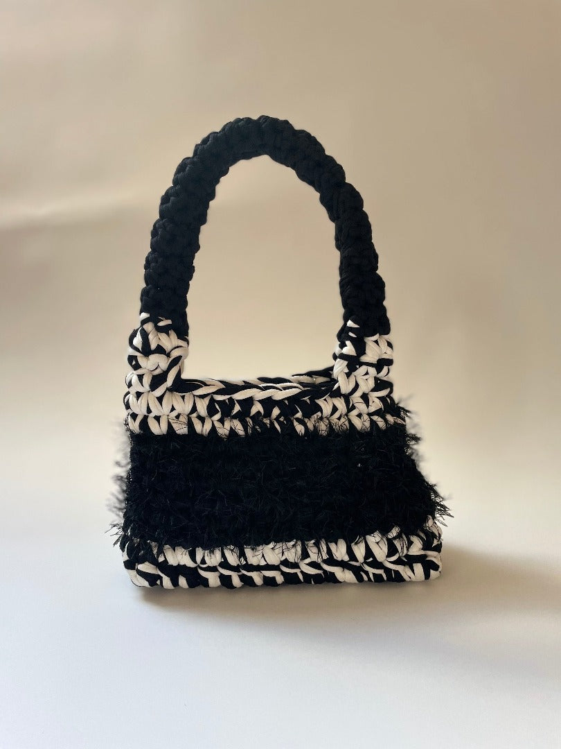 black and white crochet bag with fluffy black detailing
