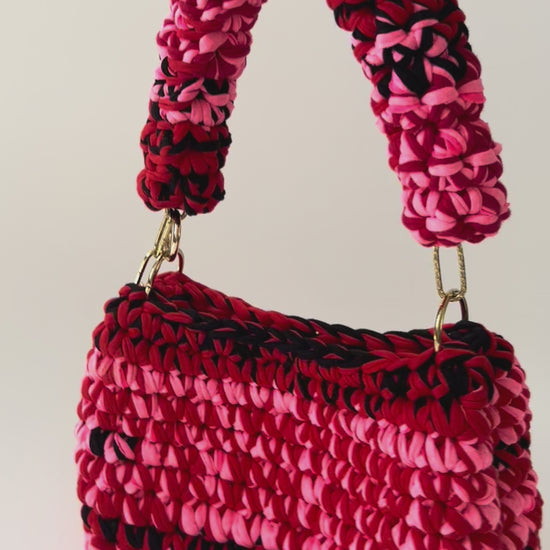 product vide of a Pink red black crochet bag handmade 