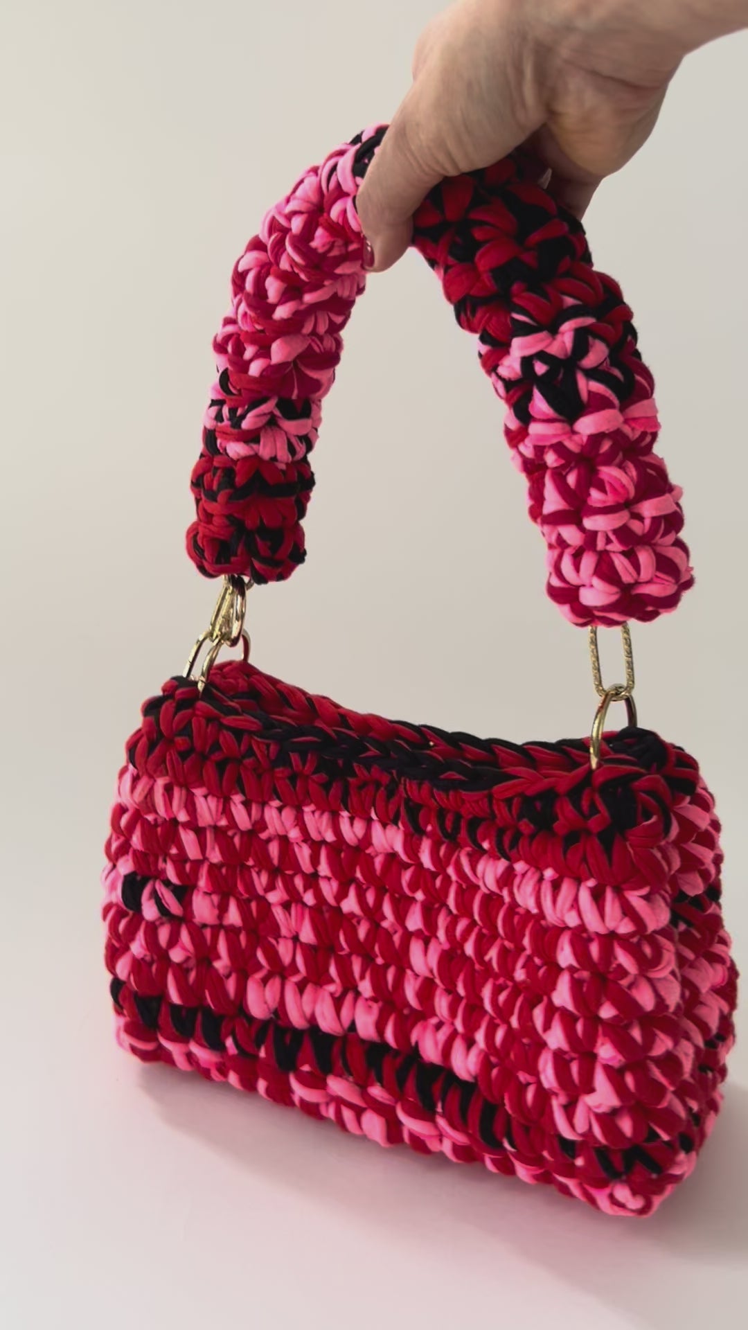 product vide of a Pink red black crochet bag handmade 